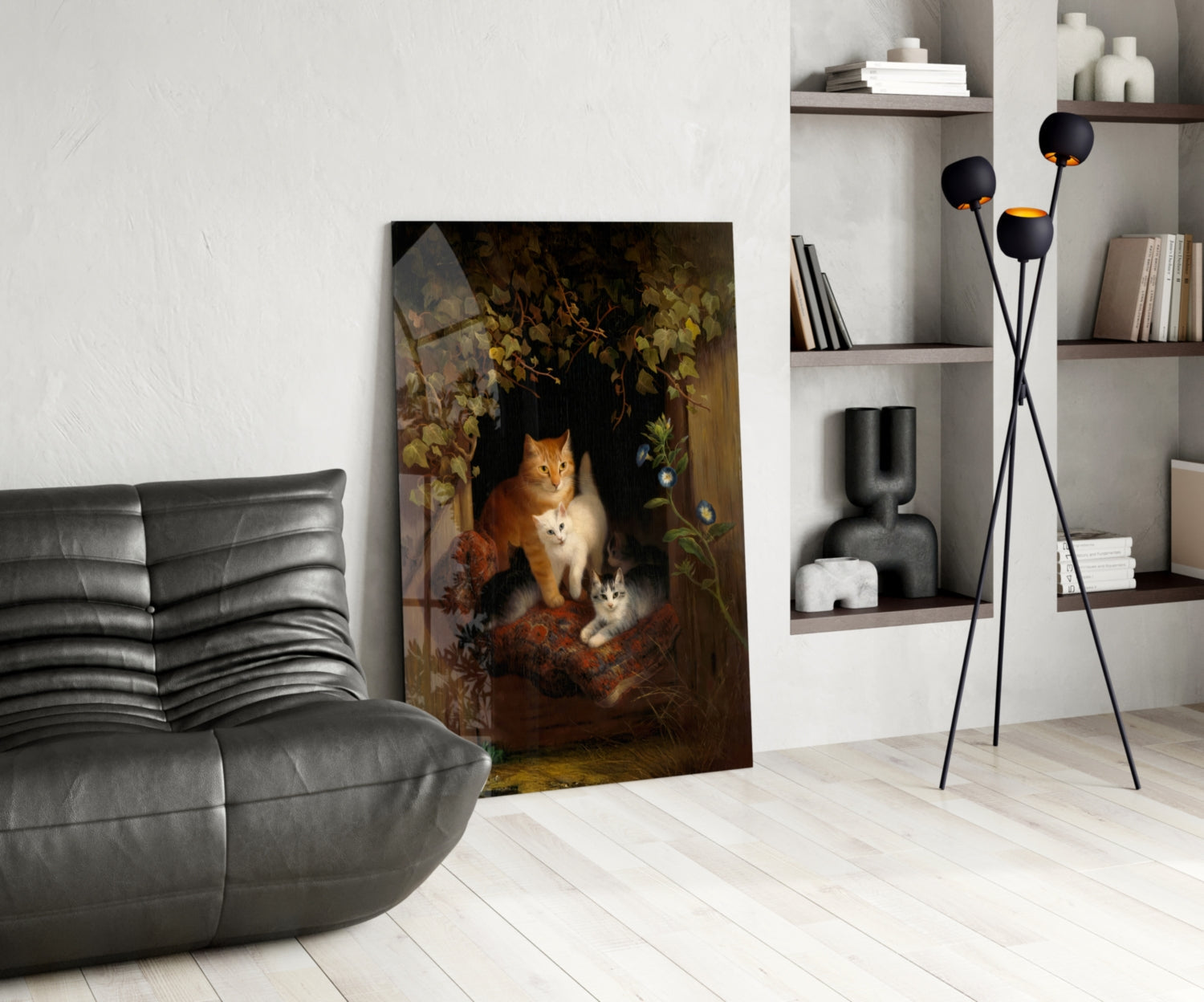 Glass wall art depicting a mother cat and two kittens in a window with golden foliage, displayed in a modern living room setting.