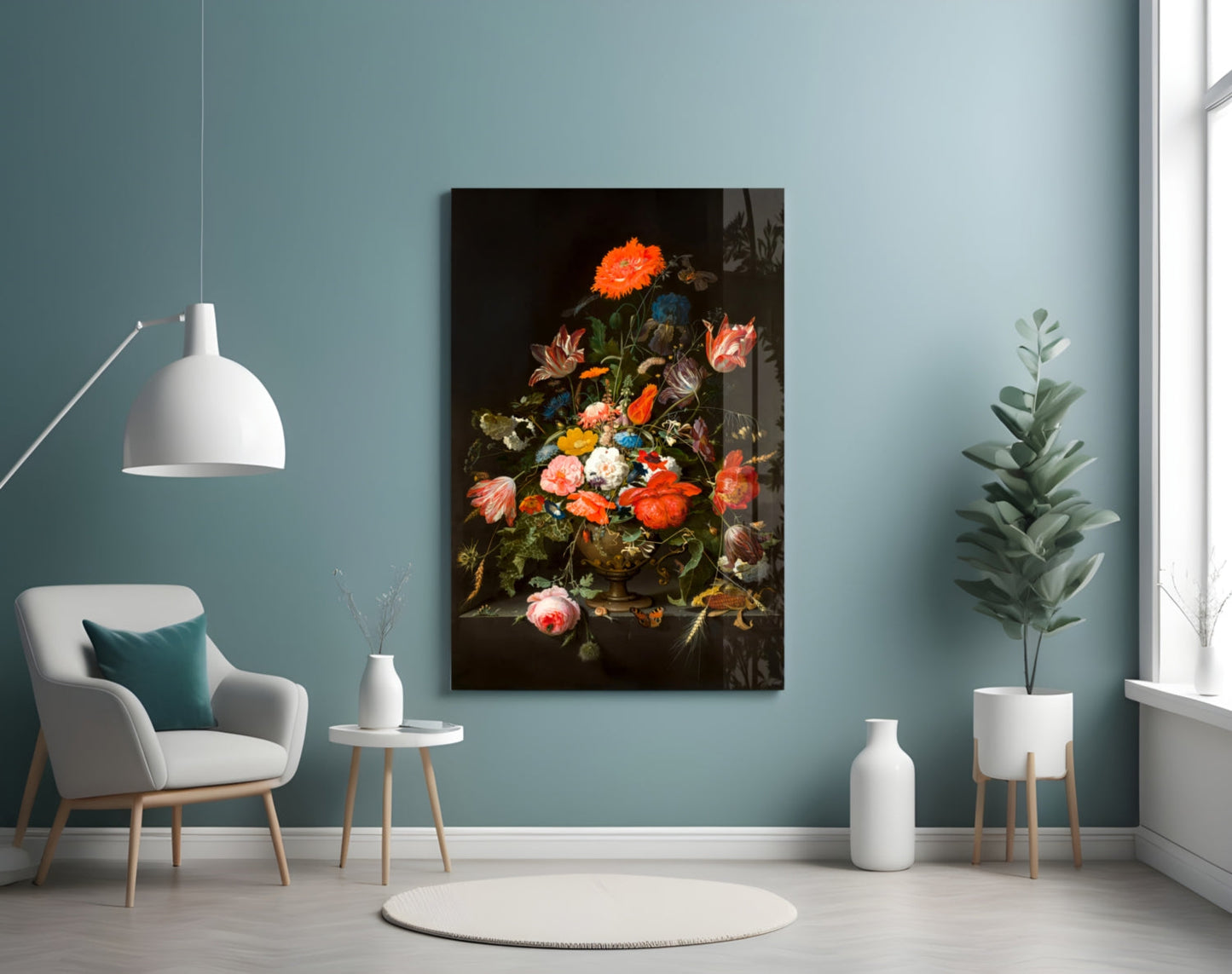 A framed floral still life painting with vibrant orange, red, and pink flowers against a dark background, displayed on a light blue wall in a modern living room setting.