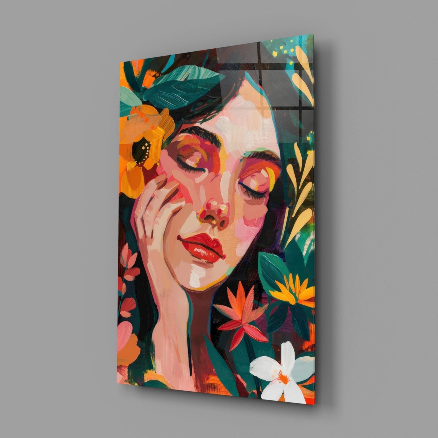 Angled view of colorful glass wall art depicting a woman's face surrounded by vibrant orange, yellow, and red flowers against dark foliage.