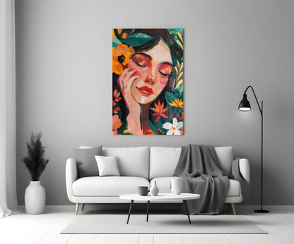 Colorful portrait glass art featuring a woman's face surrounded by vibrant flowers displayed above a white sofa in a modern living room.