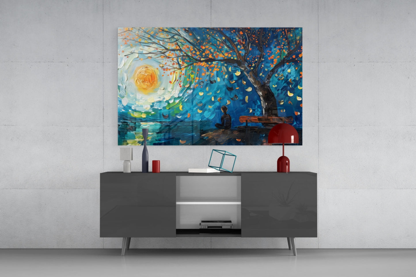 Modern living room with dark gray media console displaying glass wall art featuring a blue impressionist landscape with golden sun and falling leaves above decorative accessories.