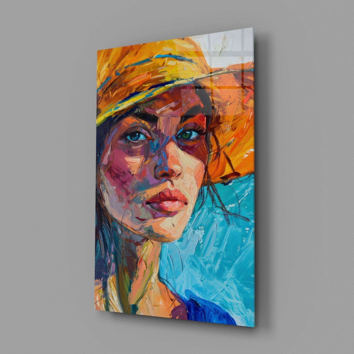 Colorful portrait of woman wearing orange hat displayed as glass wall art panel, angled view showing vibrant brushstroke style painting in blues, oranges, and purples.