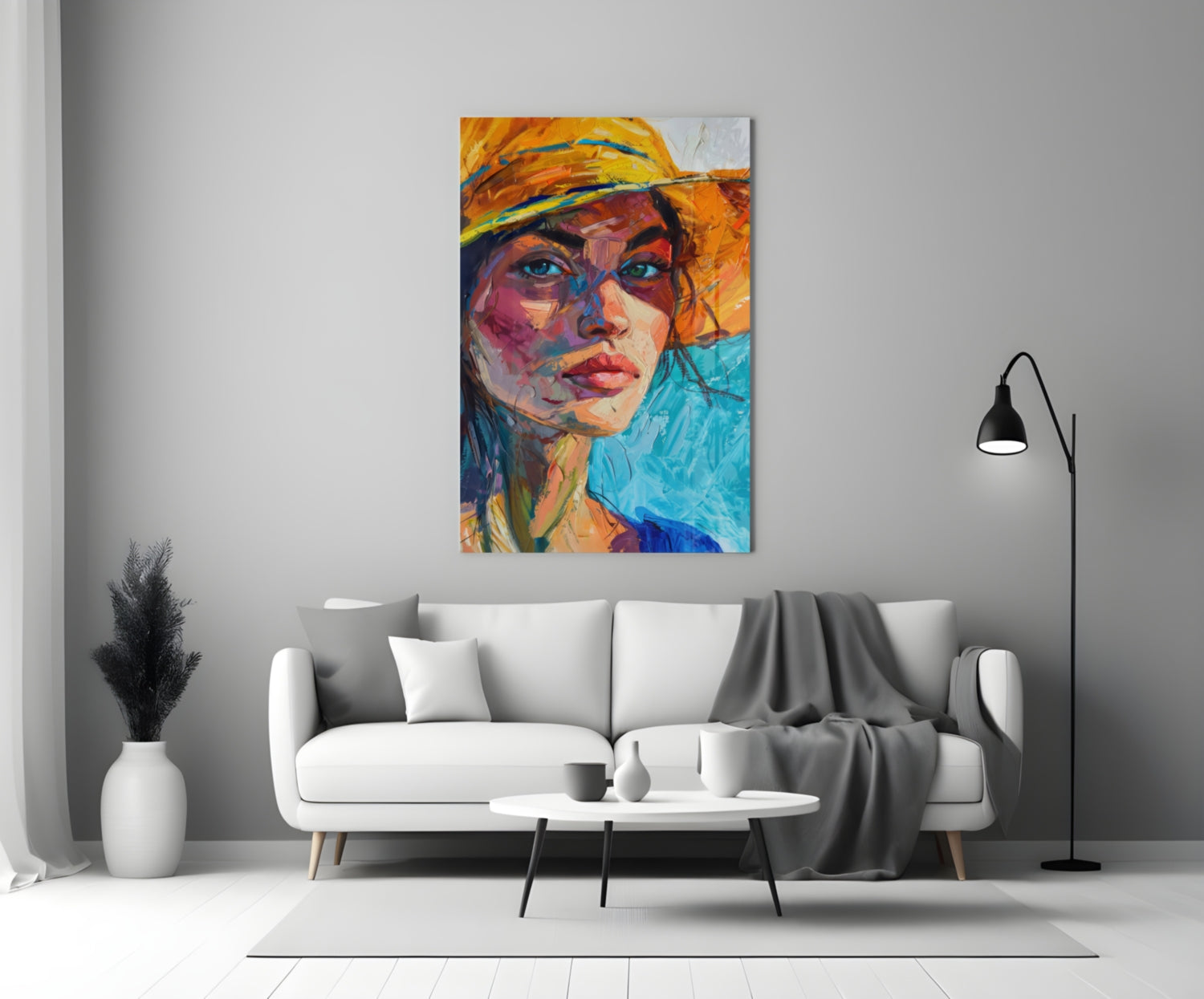 Colorful abstract portrait of woman wearing orange hat displayed above white sofa in minimalist living room setting.