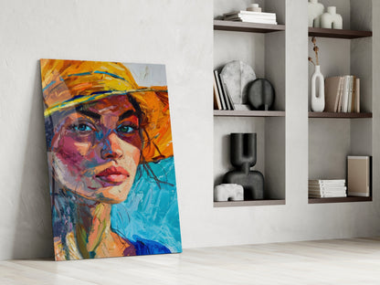 Colorful abstract portrait of woman wearing orange hat leaning against white wall beside built-in shelving with decorative objects.