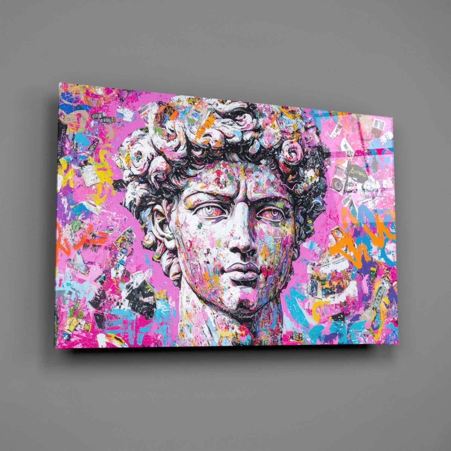 Colorful graffiti glass wall art featuring a classical marble bust with vibrant pink, blue, yellow, and orange paint splatters and street art designs on a gray background.
