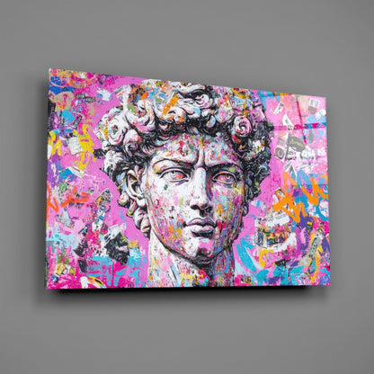 Colorful graffiti glass wall art featuring a classical marble bust with vibrant pink, blue, yellow, and orange paint splatters and street art designs on a gray background.