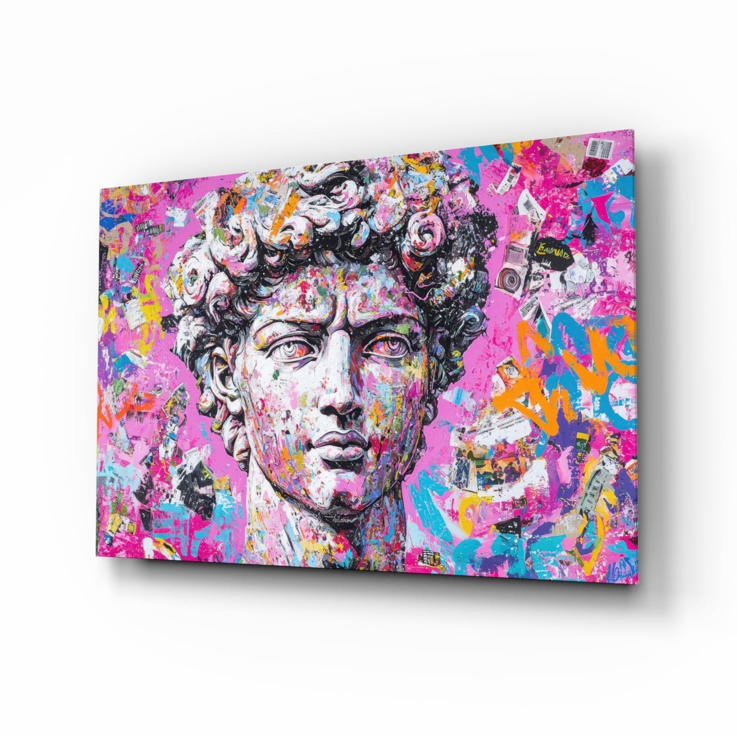Angled perspective view of colorful graffiti-style glass wall art featuring a classical bust with vibrant pink, blue, yellow, and orange paint splatters and overlaid imagery.