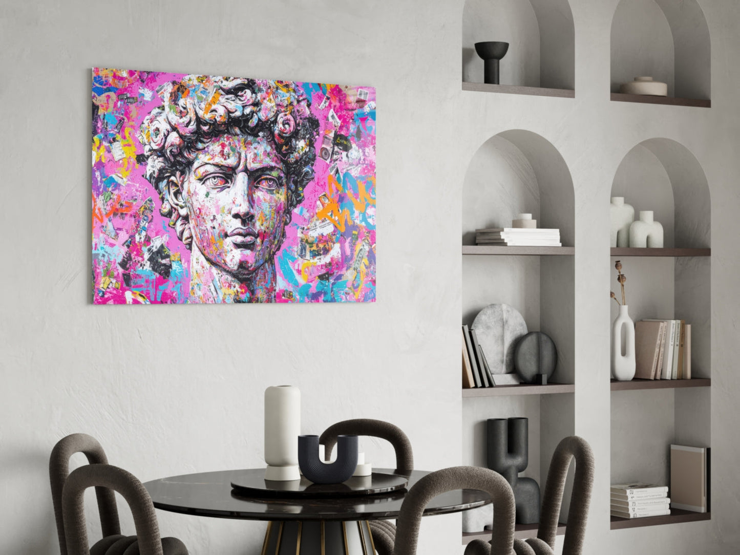 Colorful pop art glass wall panel featuring classical David bust with vibrant pink, blue, and yellow graffiti-style overlay, displayed above round black dining table in modern interior.