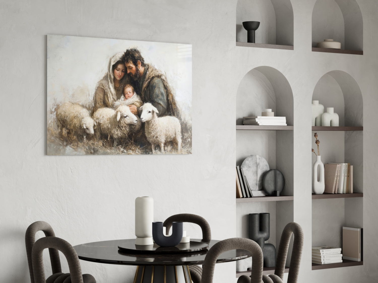 Glass wall art depicting a bearded man, woman, and child with lambs in muted earth tones, displayed above a round black dining table.