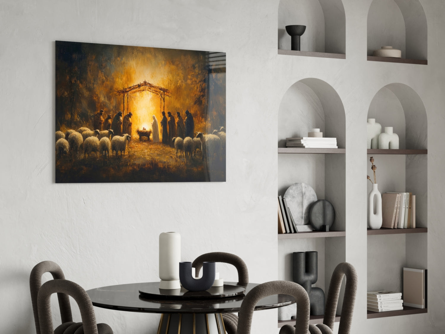Birth glass wall art depicting a nativity scene with golden light, figures, and sheep, displayed above a dining table in a modern interior.