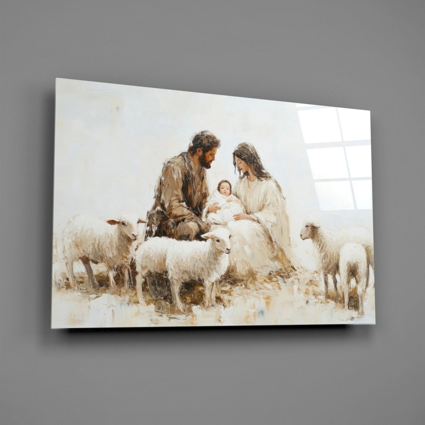 Glass wall art panel displaying a watercolor nativity scene with two figures, infant, and sheep in warm earth tones and white, mounted on gray wall.