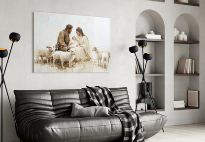 Glass wall art depicting a nativity scene with shepherds, sheep, and holy family in sepia tones, displayed above a black leather sofa in a modern living room.