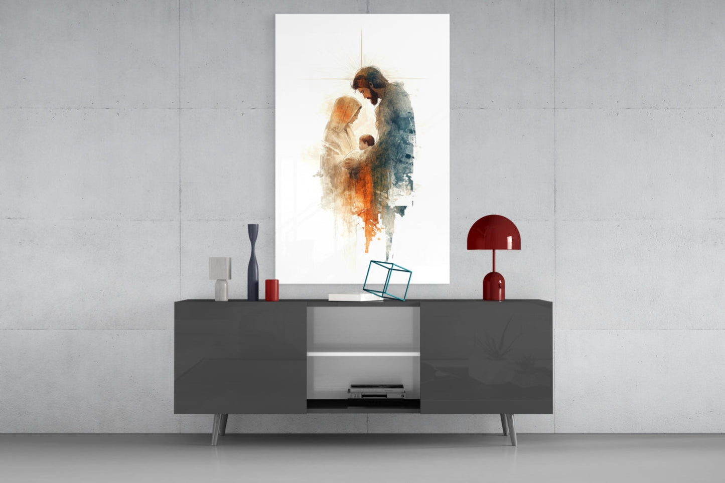 Holy Family Glass Wall Art displayed above gray media console, showing watercolor figures in warm and cool tones with cross symbol.