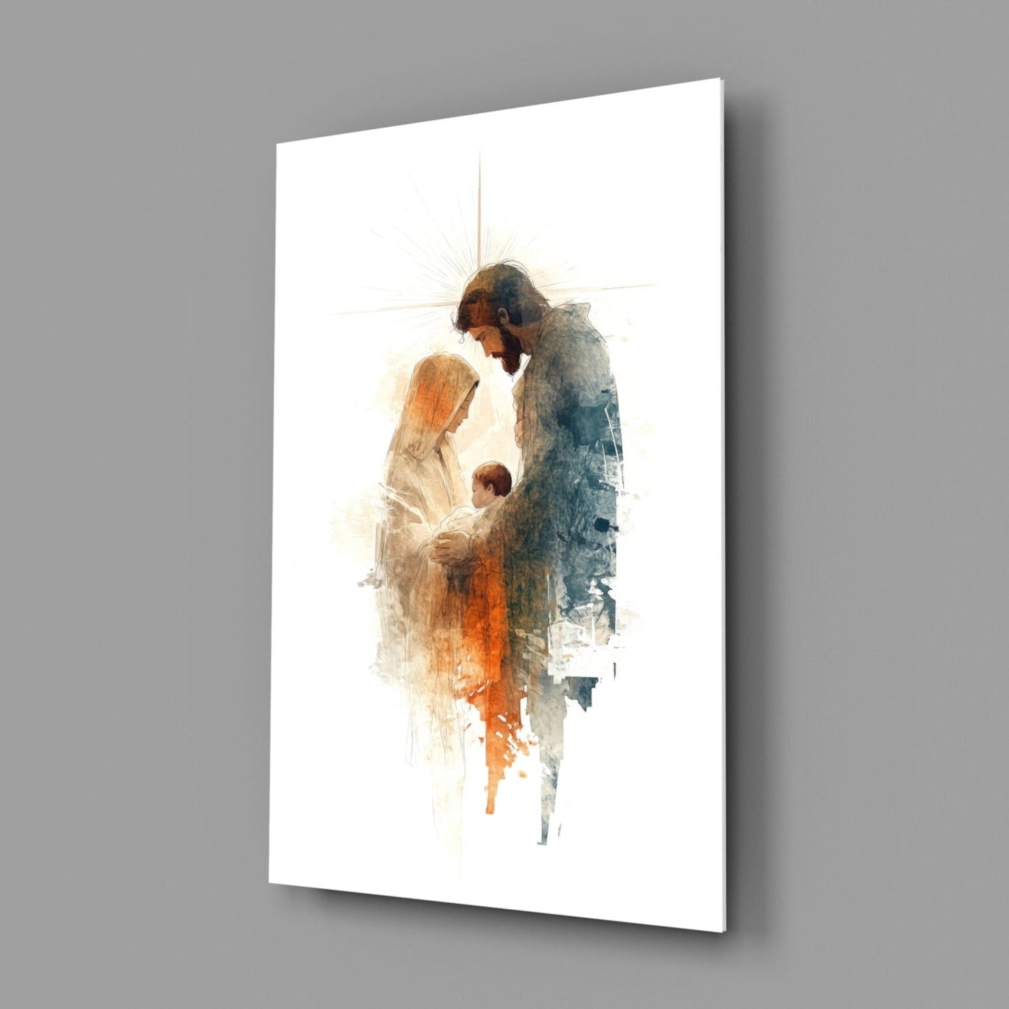 Angled perspective of glass wall art depicting Mary, Joseph, and infant Jesus with watercolor orange and blue tones on white background.