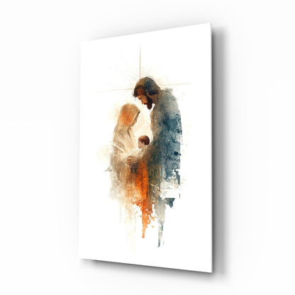 Angled perspective of glass wall art depicting Holy Family figures in watercolor style with warm orange and cool blue tones on white background.