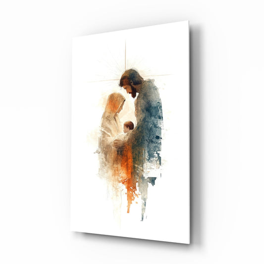 Angled perspective of glass wall art depicting Holy Family figures in watercolor style with warm orange and cool blue tones on white background.