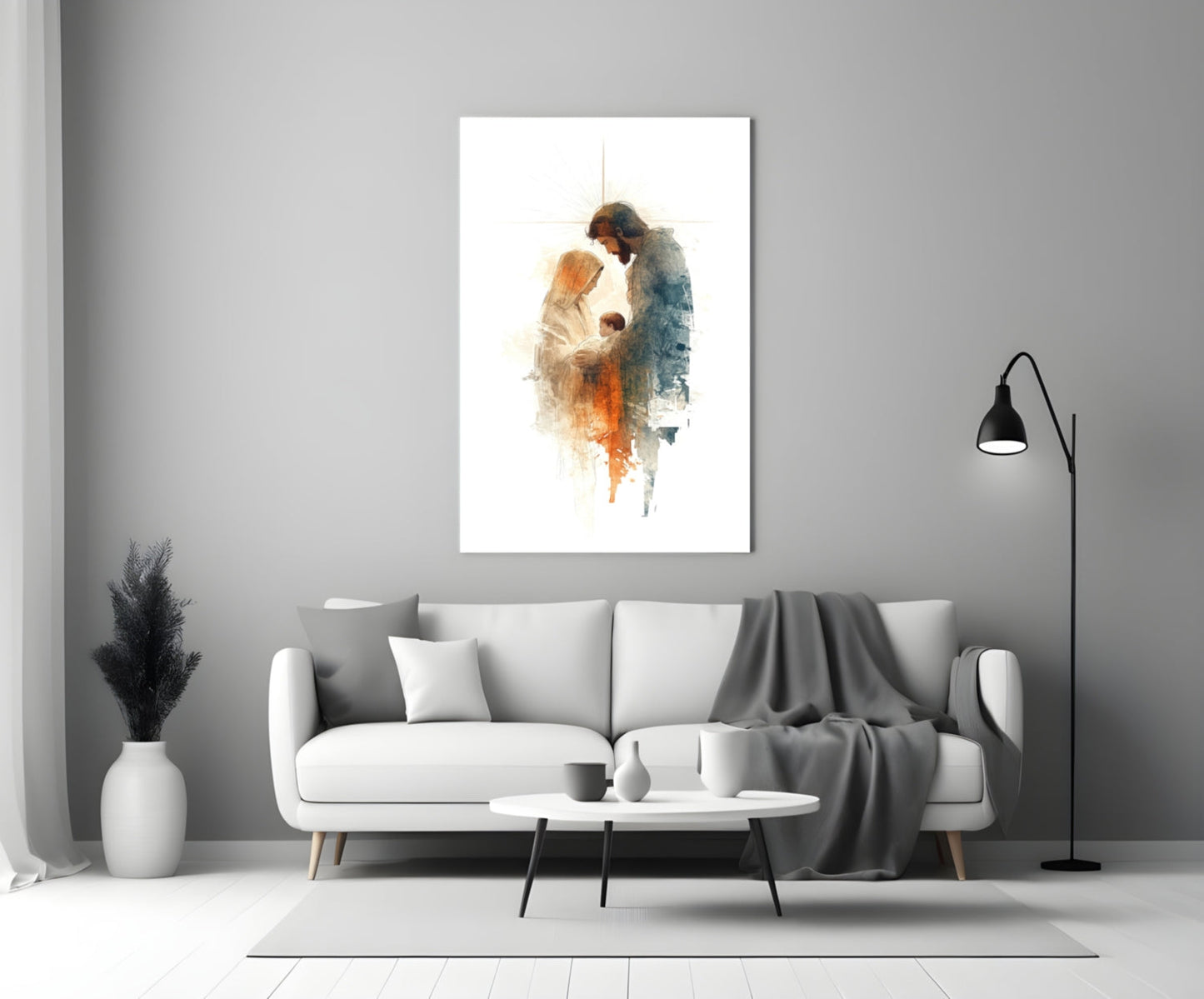 Holy Family glass wall art depicting two figures in watercolor tones displayed above white sofa in minimalist interior.