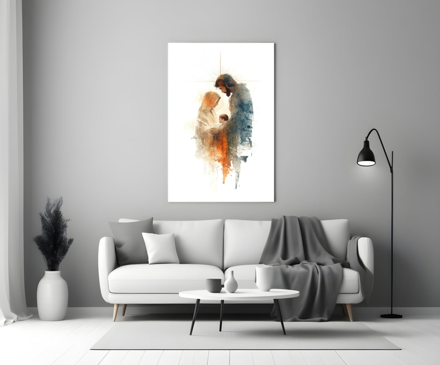 Holy Family glass wall art depicting two figures in watercolor tones displayed above white sofa in minimalist interior.