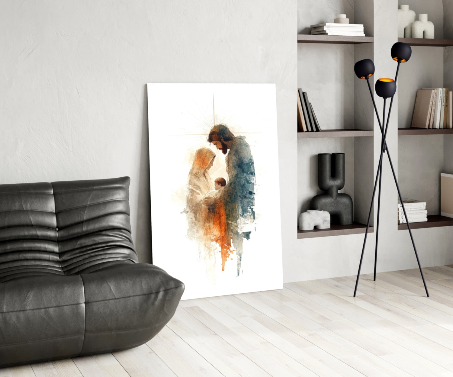 Holy Family glass wall art displayed in modern living room with black leather chair, shelving unit, and floor lamp.