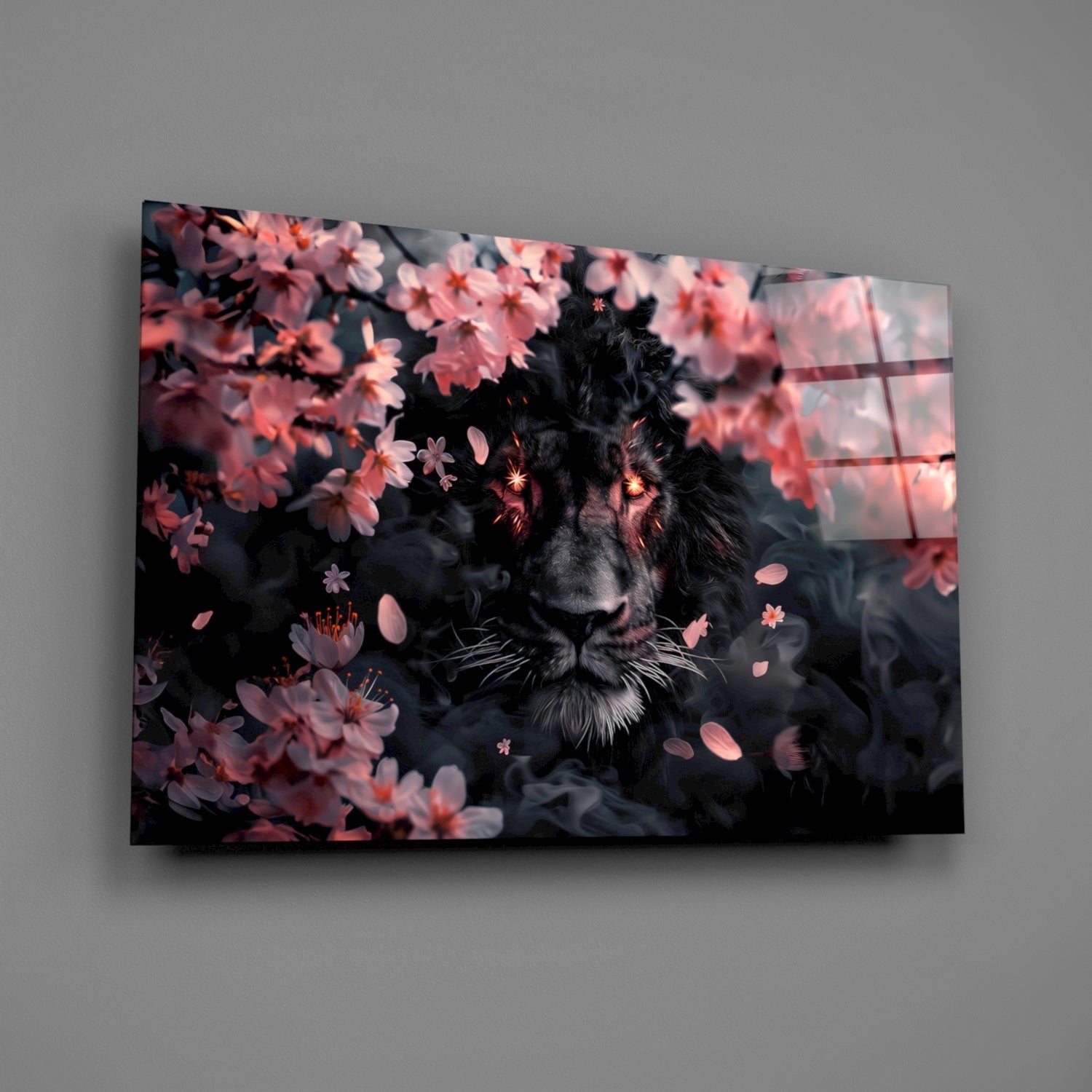 Black lion surrounded by pink blossoms displayed on angled glass wall art mounted against gray wall.