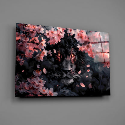 Black lion surrounded by pink blossoms displayed on angled glass wall art mounted against gray wall.