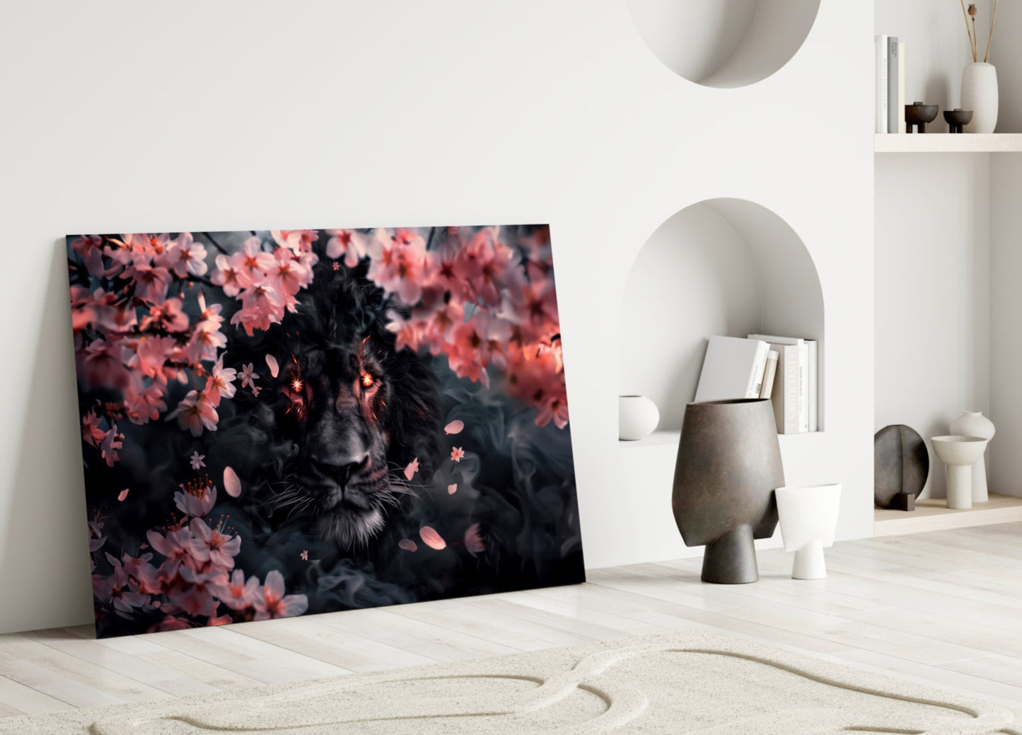 Glass wall art featuring a dark lion surrounded by pink blossoms, displayed leaning against white interior wall with decorative objects.