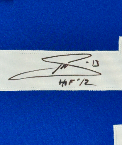 Close-up of handwritten signature and "HOF 12" text on white mat strip between blue fabric sections.