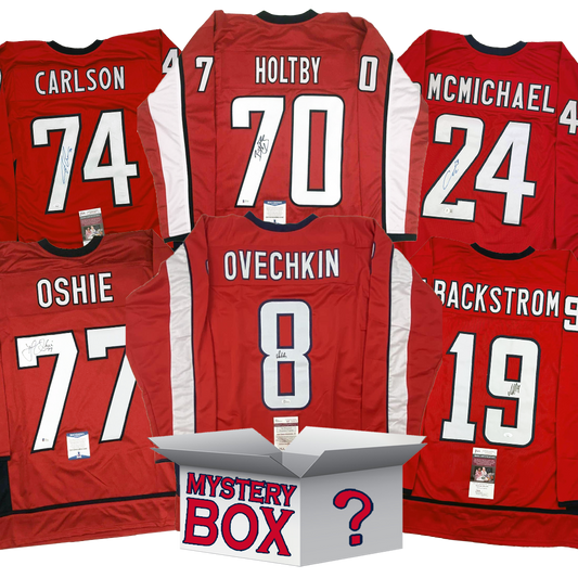 Five signed red hockey jerseys arranged around a white mystery box with question mark, displaying player names Carlson, Holtby, McMichael, Oshie, and Ovechkin with visible authentication labels.
