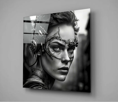 Black and white glass wall art depicting a cyborg woman in profile with mechanical headgear and facial augmentations, mounted on gray wall.