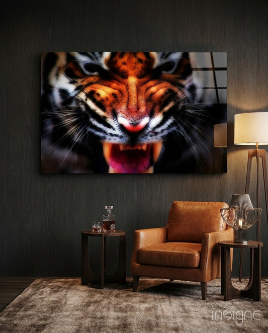 Snarling tiger amber glass wall art displayed above a cognac leather chair in a modern living room with dark textured walls.