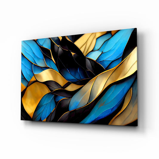 Abstract glass wall art featuring layered blue, gold, and black leaf shapes with metallic accents, displayed at an angled perspective.
