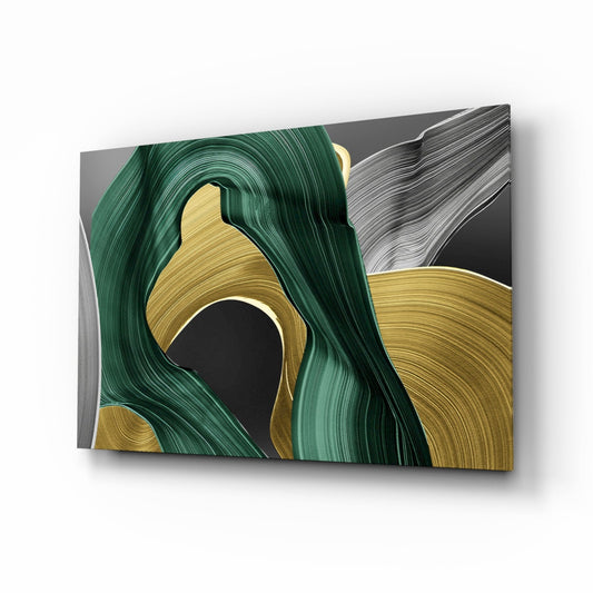 Angled perspective view of glass wall art showing swirling brushstroke patterns in deep green, gold, and gray tones.