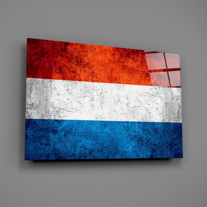 Netherlands flag glass wall art displayed at an angle against gray background, showing red, white, and blue horizontal stripes with distressed texture.