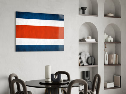 Costa Rican flag glass wall art with blue, white, and red horizontal stripes displayed above a dining table in a modern interior.