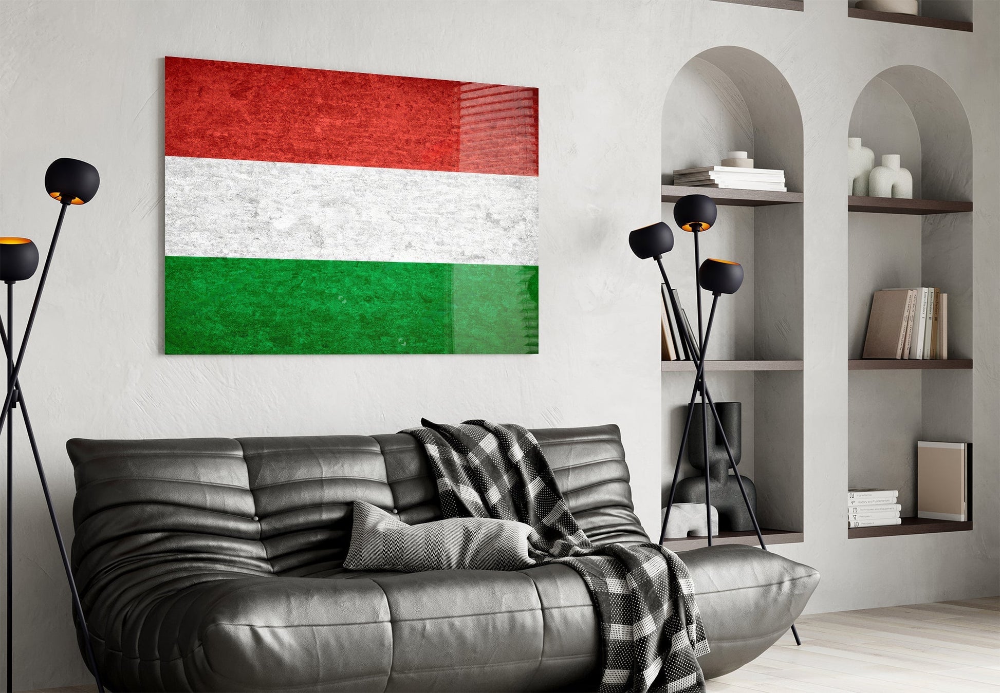 Hungarian flag glass wall art displaying red, white, and green horizontal stripes hung above black leather sofa.