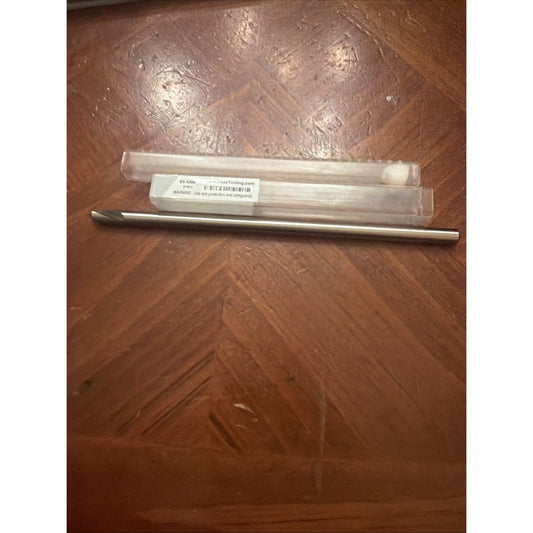 Haas carbide chamfer mill in clear plastic case with label on wooden floor, top view showing metallic tool and packaging.