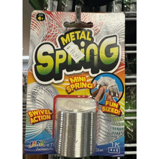 Metal spring toy in silver cylinder form displayed in colorful retail packaging with yellow and red text labeling.