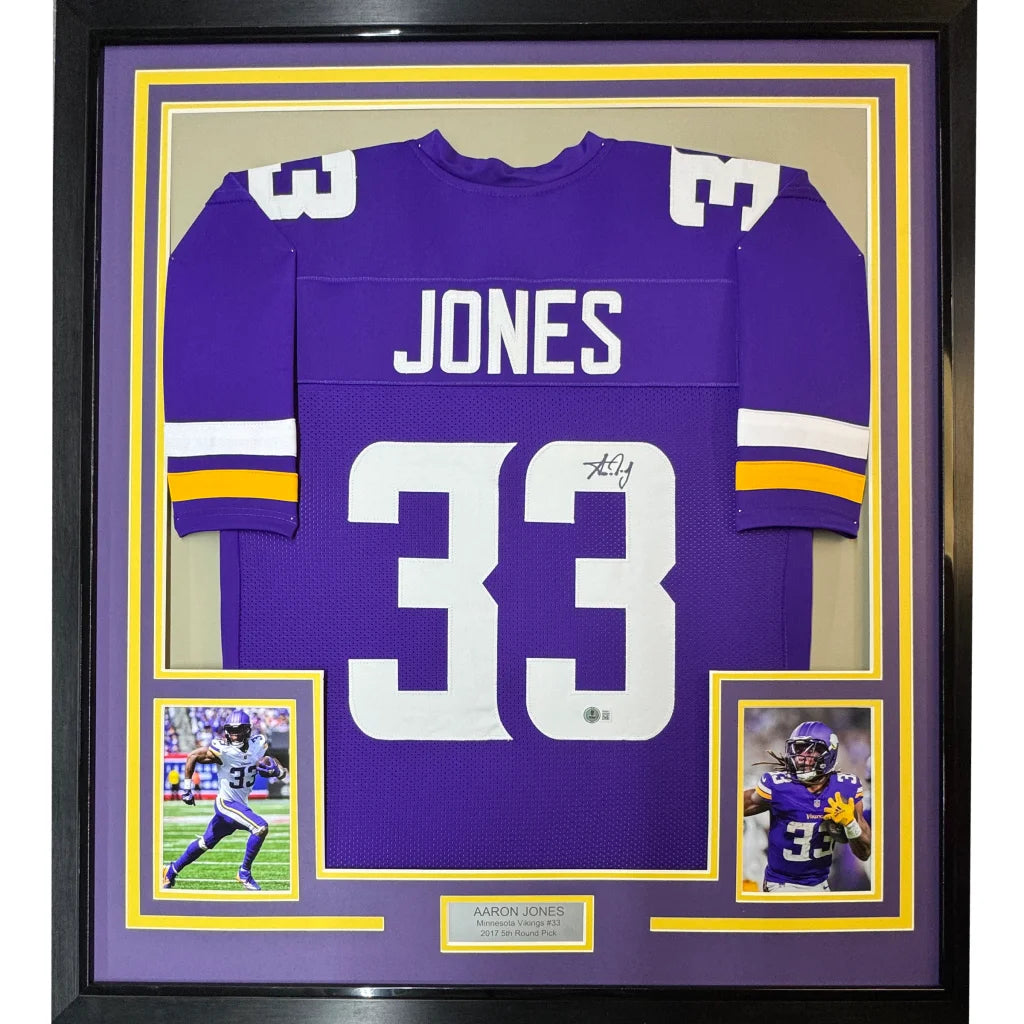 Framed Aaron Jones #33 Minnesota Vikings signed jersey with player photos and engraved plaque