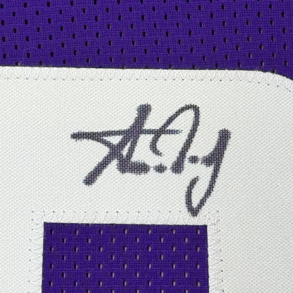 Purple Minnesota Vikings jersey with a white patch and black autograph for Aaron Jones