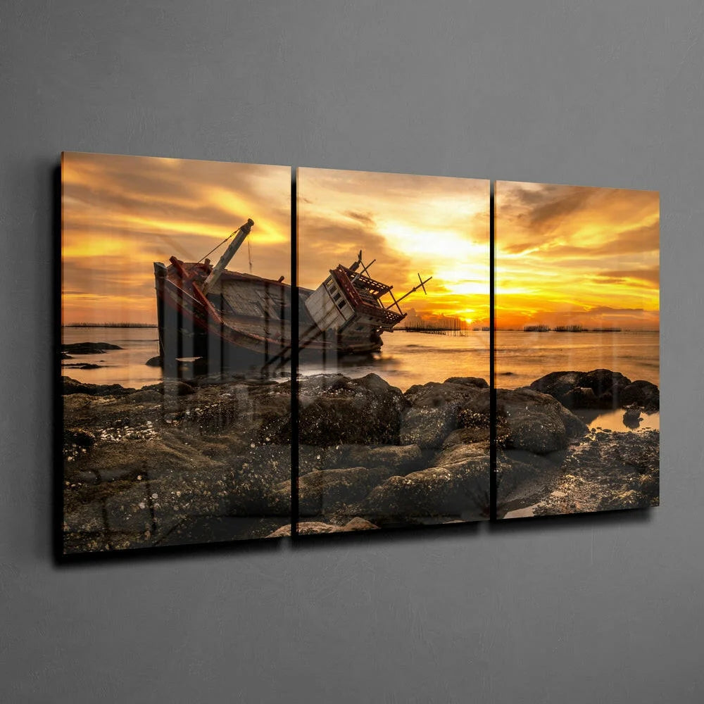 Stunning sunset shipwreck canvas wall art triptych with boat on rocky shore