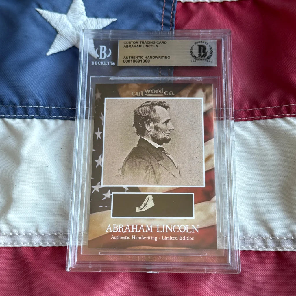 A framed abraham lincoln legal document card featuring his portrait and authentic handwriting in a clear slab