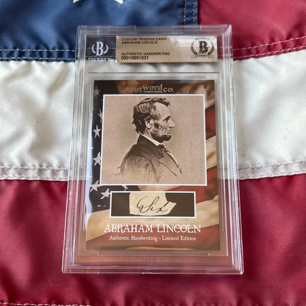 A framed abraham lincoln legal document trading card featuring authentic lincoln handwriting fragments in a clear slab