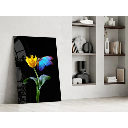 Vibrant yellow tulip with blue butterfly on sleek black glass wall art canvas
