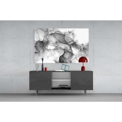 Abstract black and white inkblot wall art above gray console