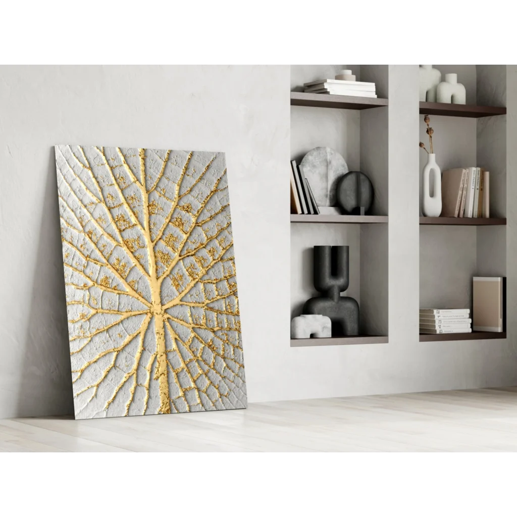 Textured gray and gold leaf-patterned wall art with raised intricate design