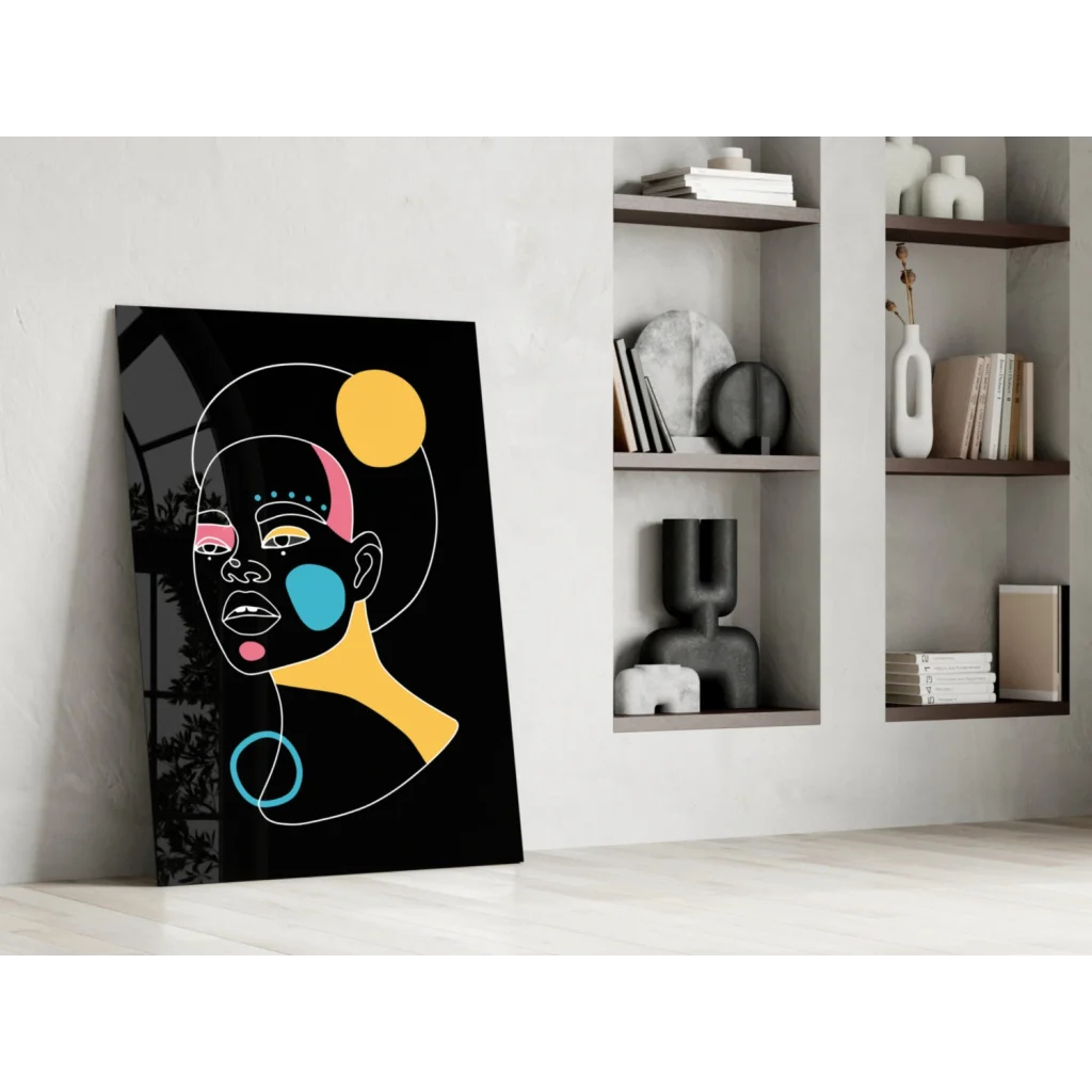 Bold geometric face glass wall art in vibrant yellow, pink, blue, white on black