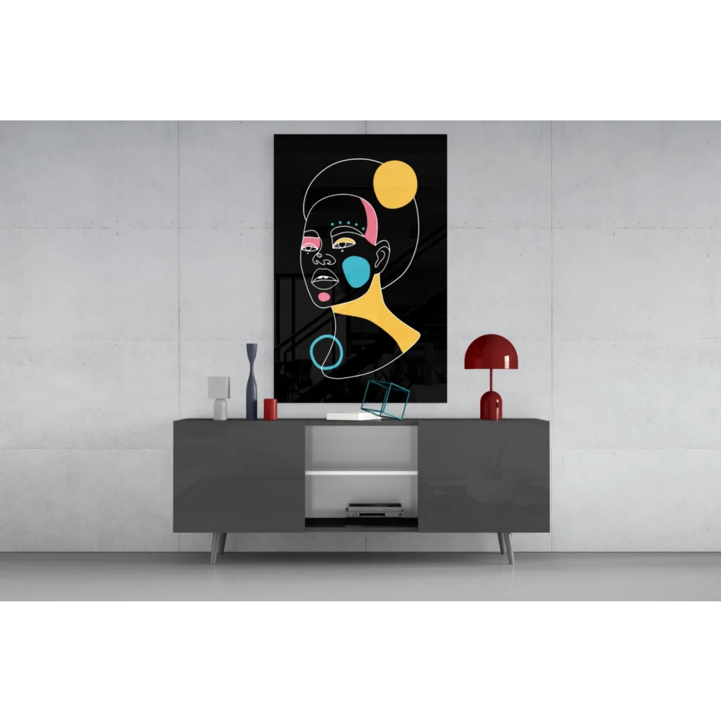 Bold geometric face glass wall art in vibrant yellow, pink, teal on black