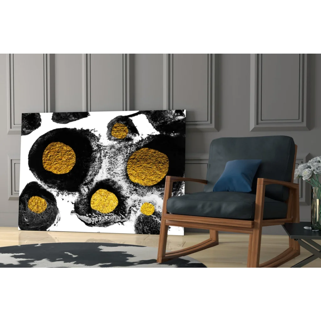 Black and gold abstract glass wall art with textured circular patterns