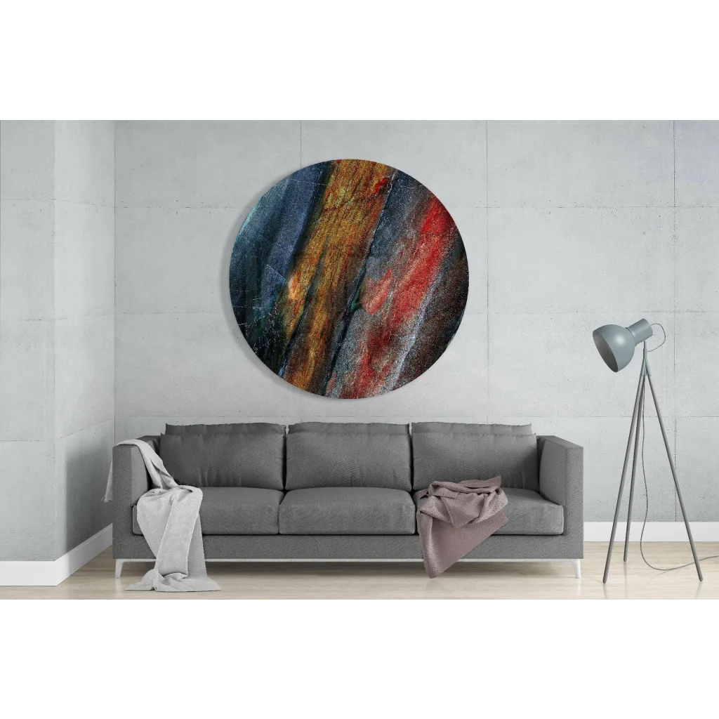 Fiery swirl tempered glass art with red, orange, blue streaks above sofa