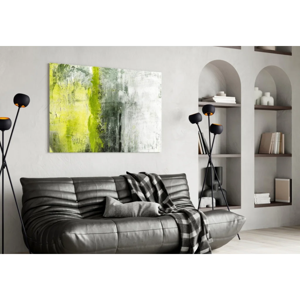 Black leather sofa with plaid throw beside electric lime green wall art